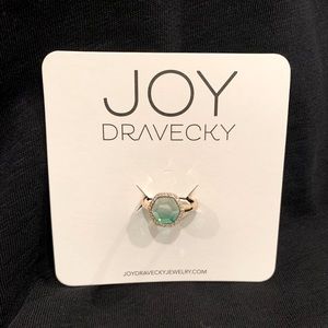 The Chloe ring encases an ombre green glass stone in cubic zirconia pave.